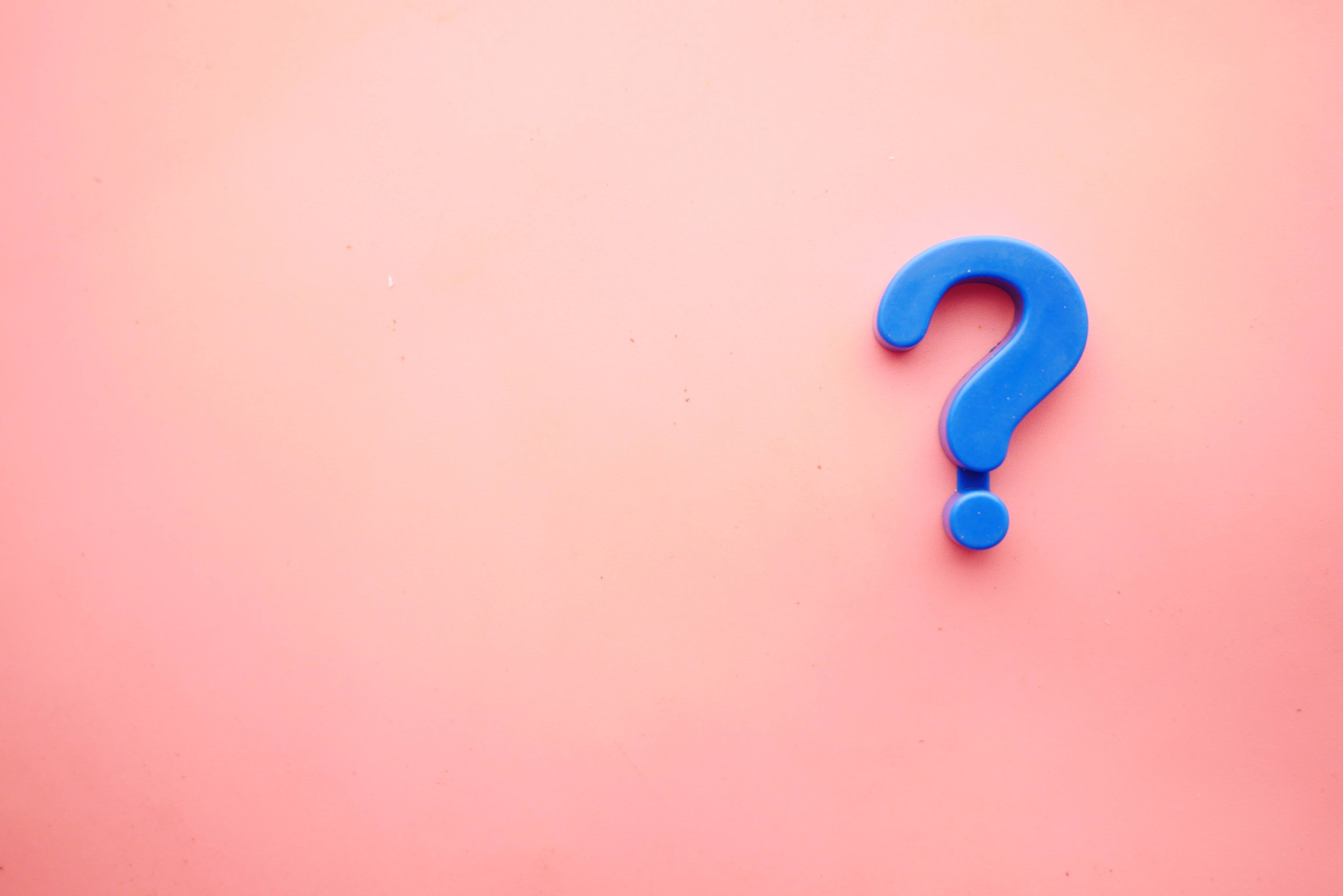 Blue question mark on a pink background. Image by Towfiqu barbhuiya